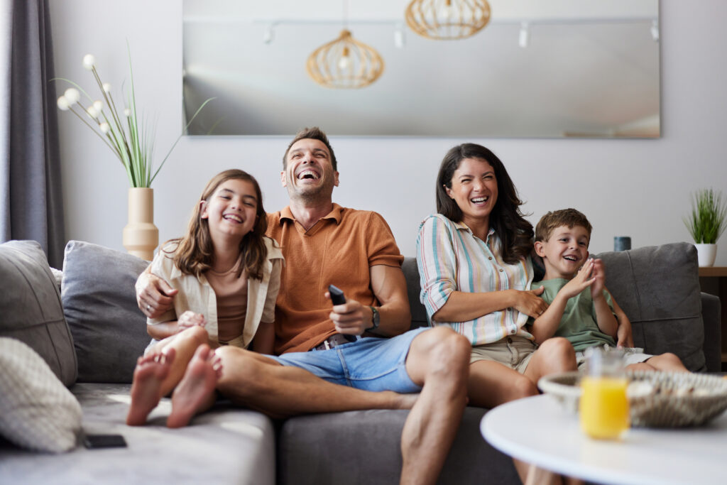 Family on couch laughing